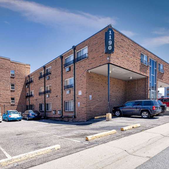a parking lot in front of a brick building with the number 190 on it  at 1190 s bellaire st in denver, co