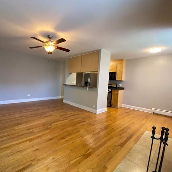 nice hardwood flooring and a ceiling fan in the living area - two bedroom