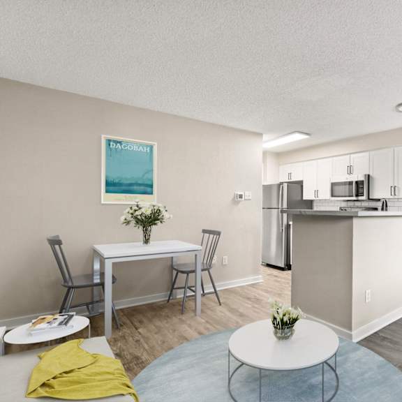open-concept kitchen and dining space with stainless steel appliances, bar seating, and cozy living area at 1443 elizabeth in denver, co