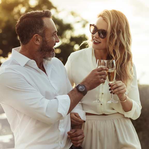 a man and a woman holding glasses of wine