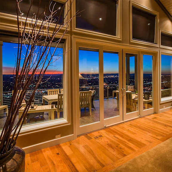a living room with a view of the city at night