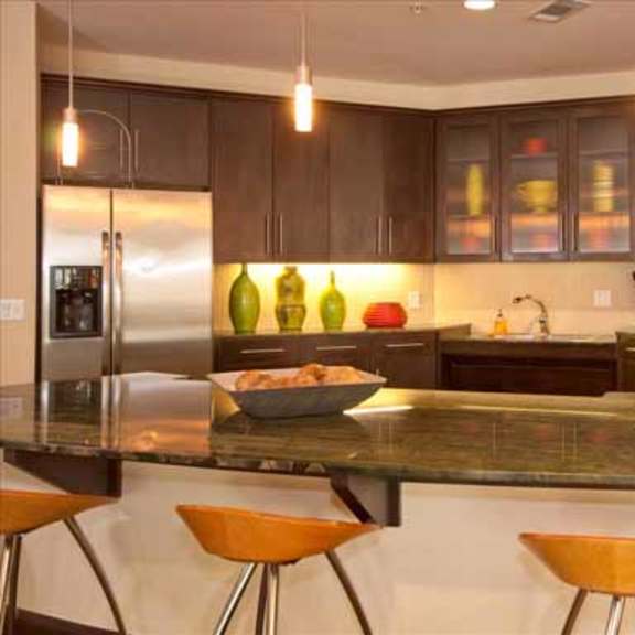 a large kitchen with an island and stainless steel appliances