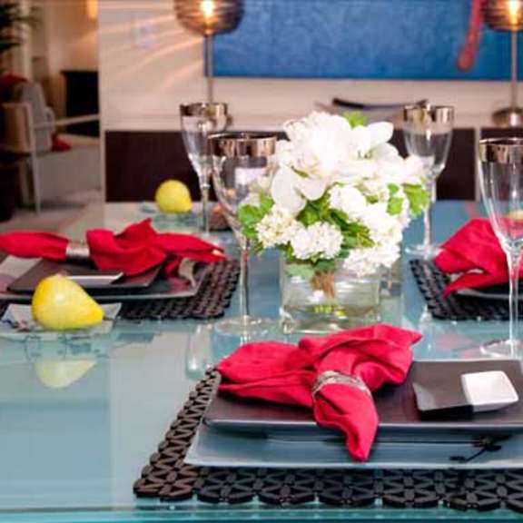 a table with plates and wine glasses and flowers on it