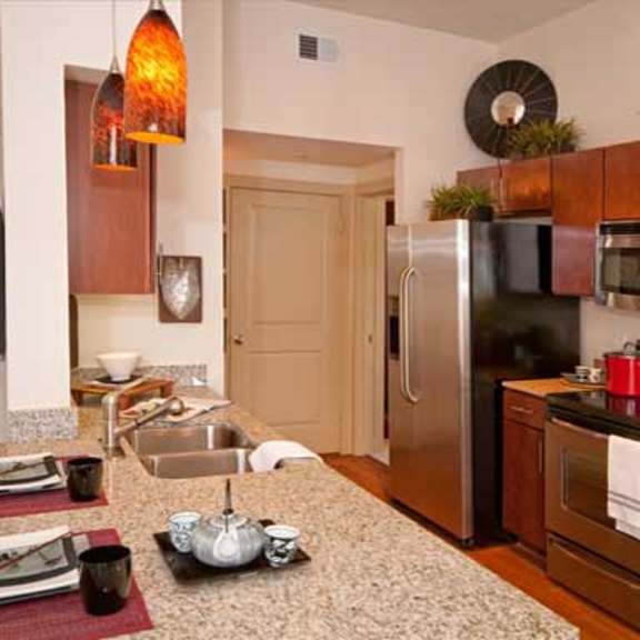 a kitchen with stainless steel appliances and granite counter tops