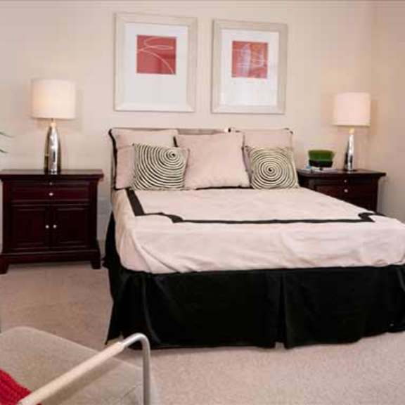 a bedroom with a bed and a chair