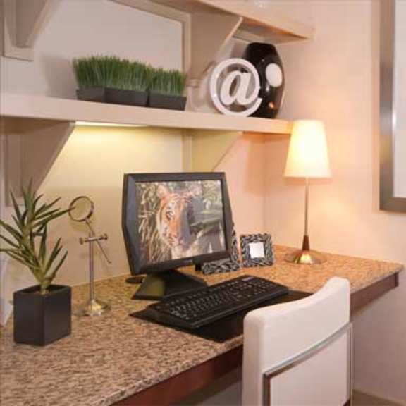 a desk with a computer monitor and a keyboard on it
