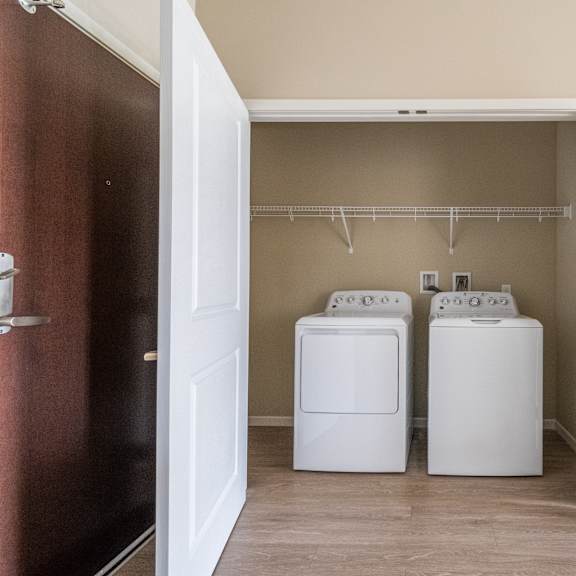a washer and dryer in the laundry room of a manufactured home at the winslow 62+ apartments, west st paul, mn