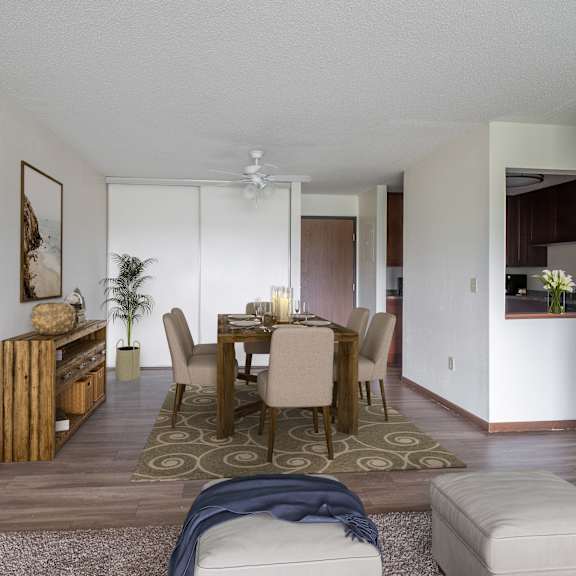 a dining room and living room with white walls and wood floors at pheasant park apartments, new hope