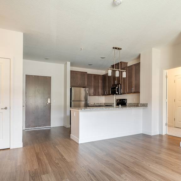 a kitchen and living room with hardwood floors and white walls at sonder house, brooklyn center, mn, 55430