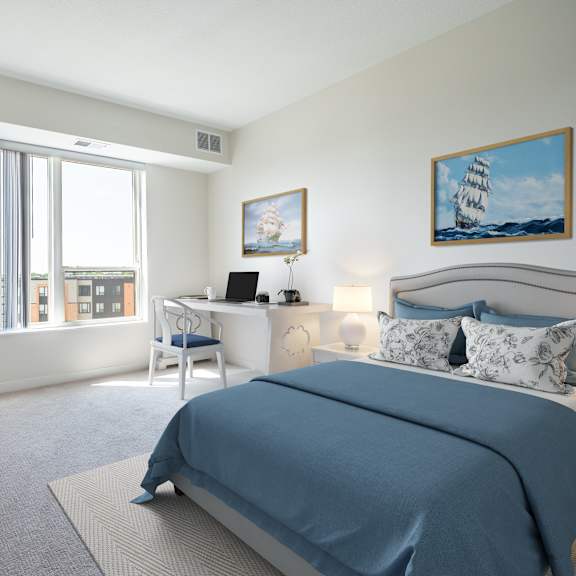 a bedroom with a bed and a desk with a computer at sonder point 50+ apartments, brooklyn center, mn, 55430