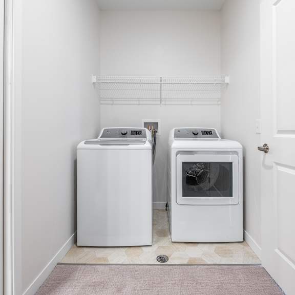 a washer and dryer in a laundry room at sonder point 50+ apartments, minnesota