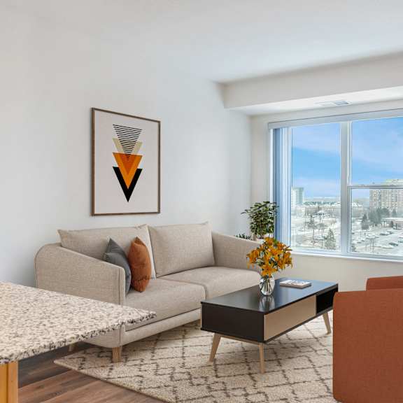 a living room with a couch and a table and a window