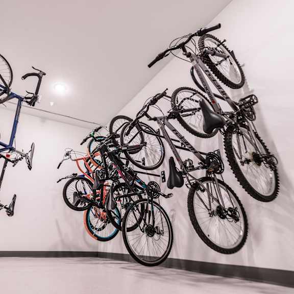a group of bikes hanging on the wall in a room