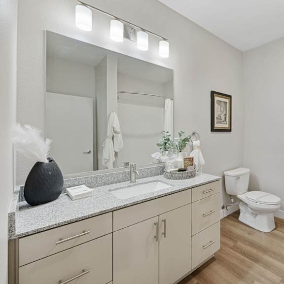 a bathroom with a white towel hanging on the towel rack.