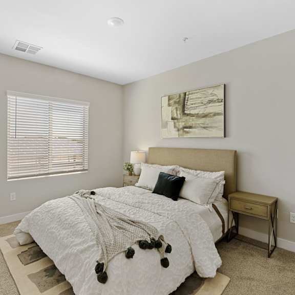 a bedroom with a large bed and a painting on the wall.