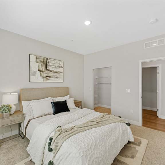 a bedroom with a large bed and a painting on the wall.