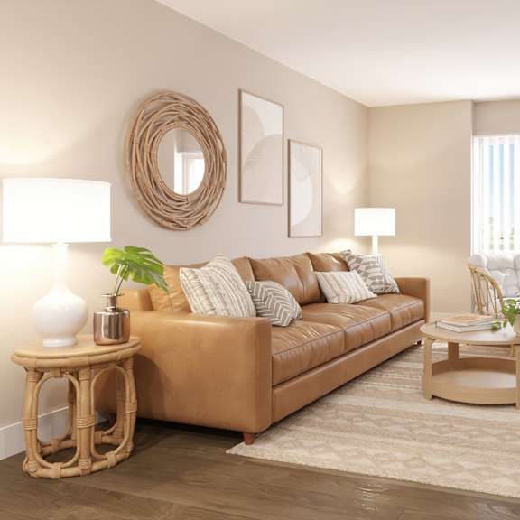 a living room with a brown sofa, a wicker table, and a flat screen tv.