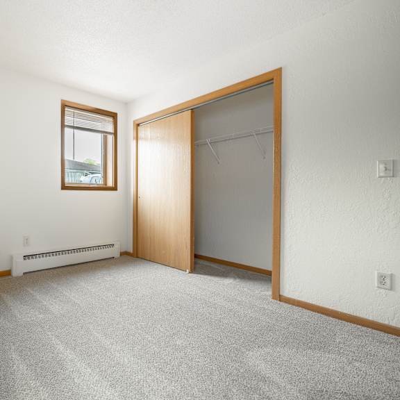 an empty room with a closet and a window at ames lake neighborhood apartments, st. paul, 55106