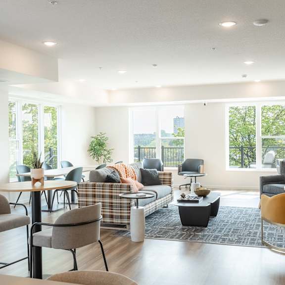 a living room with a couch, chairs, and a television.