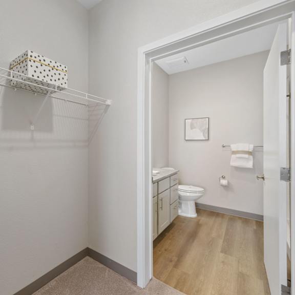 a white bathroom with a toilet and a white cabinet at copa flats apartments, apartments, maricopa, az