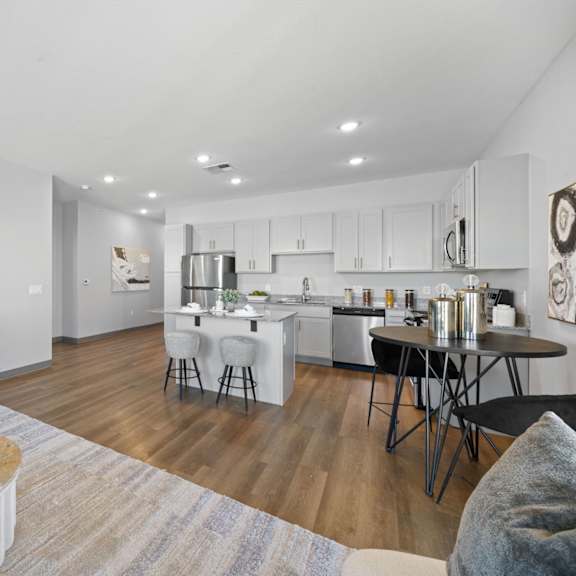a modern kitchen with a dining table and chairs at copa flats apartments, maricopa, arizona