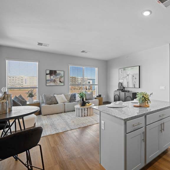 a modern kitchen with a dining table and chairs at copa flats apartments, apartments, maricopa, az