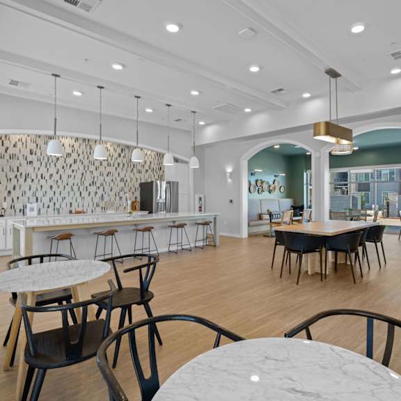 a modern dining area with a long table and chairs at copa flats apartments, arizona, 85138