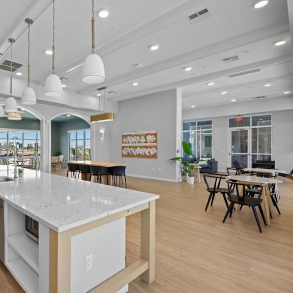 a modern kitchen with a large island and pendant lights at copa flats apartments, apartments, maricopa, az