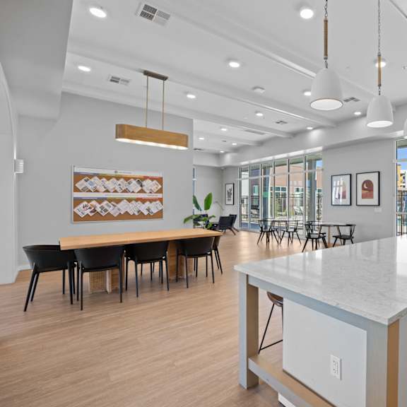 a modern kitchen with a long island and a dining table with chairs at copa flats apartments, maricopa, 85138
