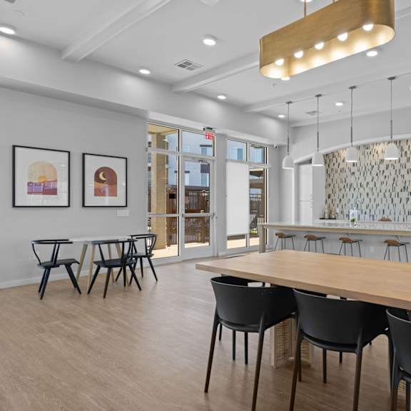 a modern dining room with a long table and chairs at copa flats apartments, maricopa, az, 85138