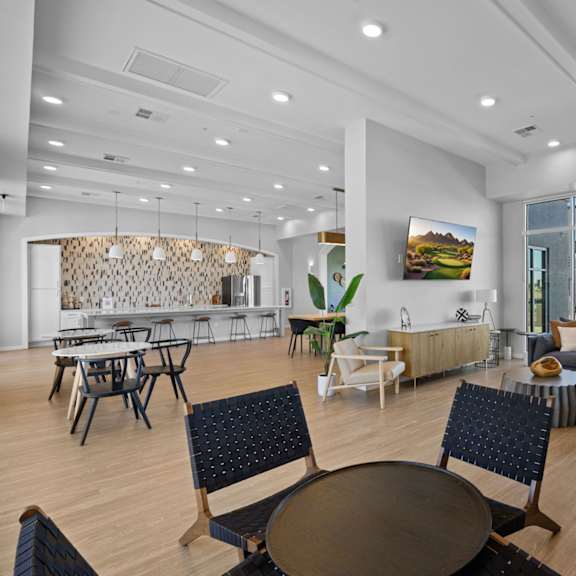 a modern living room with a dining area and a view of the outdoors at copa flats apartments, arizona