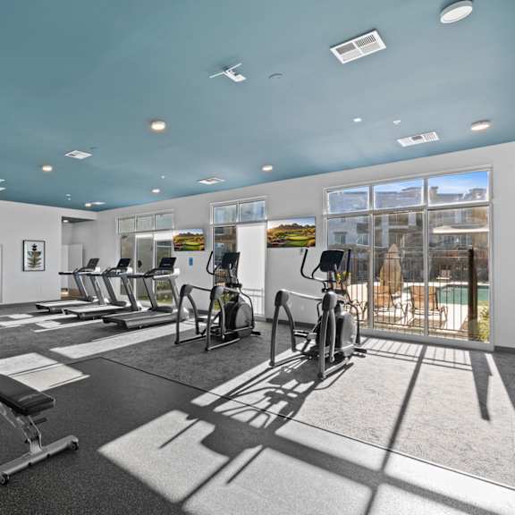 a gym with a variety of equipment including treadmills, weights, and exercise bikes at copa flats apartments, maricopa, 85138