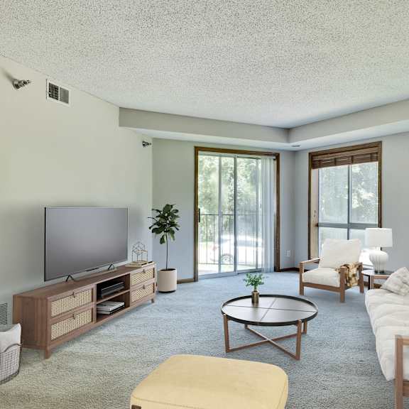 a living room with a television, couch, and coffee table. at crosby pointe apartments, st. paul  55116-3244