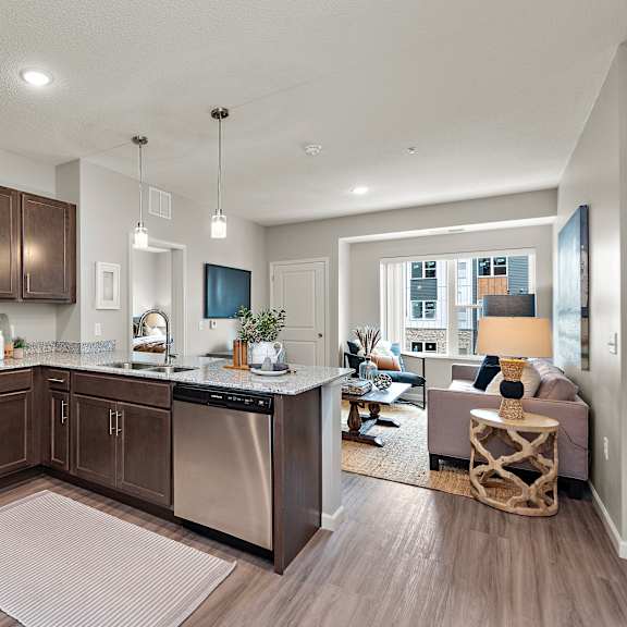 a modern kitchen with dark wood cabinets and stainless steel appliances.at decatur landing i & ii, minnesota, 55445