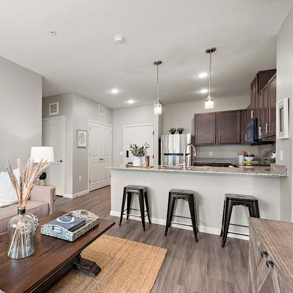 living area with kitchen view at decatur landing i & ii, brooklyn park, mn 55445