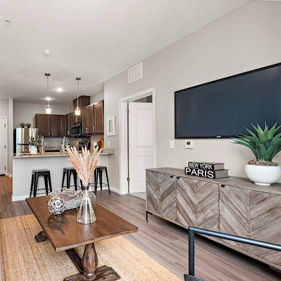 living room with kitchen view at decatur landing i & ii, brooklyn park minnesota