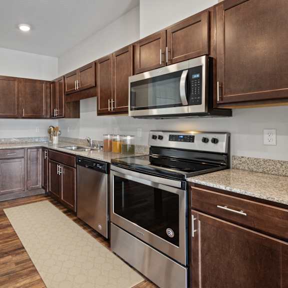 a kitchen with stainless steel appliances and granite counter tops at eastgate apartments, rochester, mn