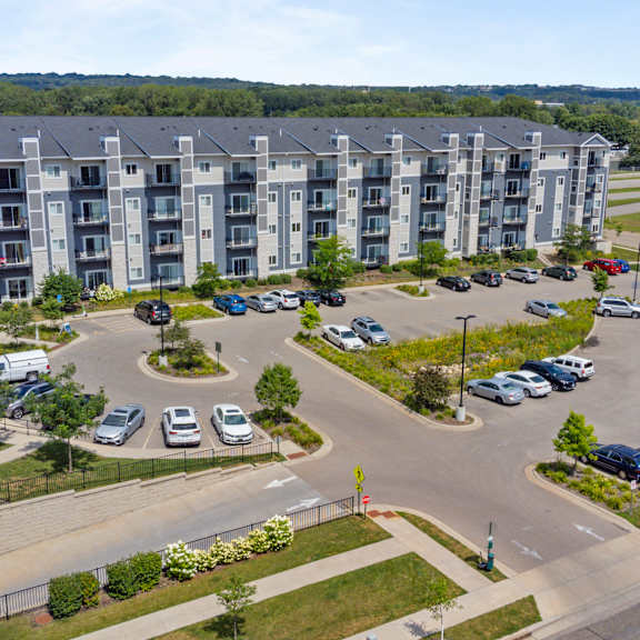 an aerial view of an apartment complex with parking lot and cars at eastgate apartments, rochester