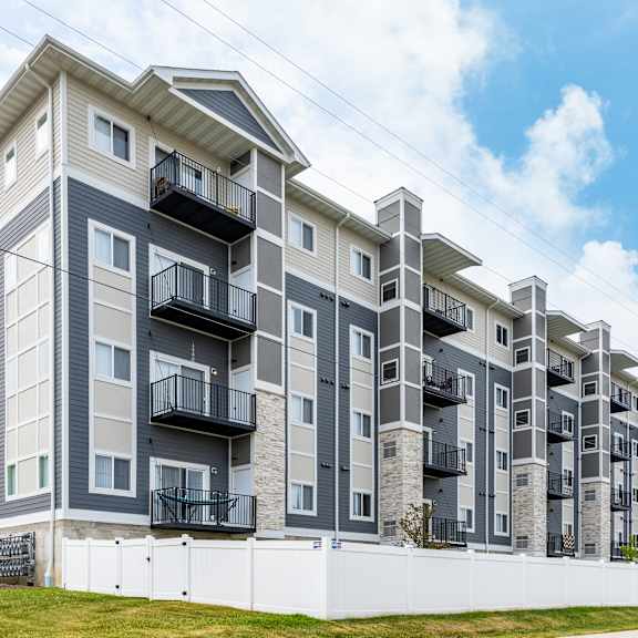 a large apartment building with balconies and a blue sky in the background at eastgate apartments, rochester, mn, 55904