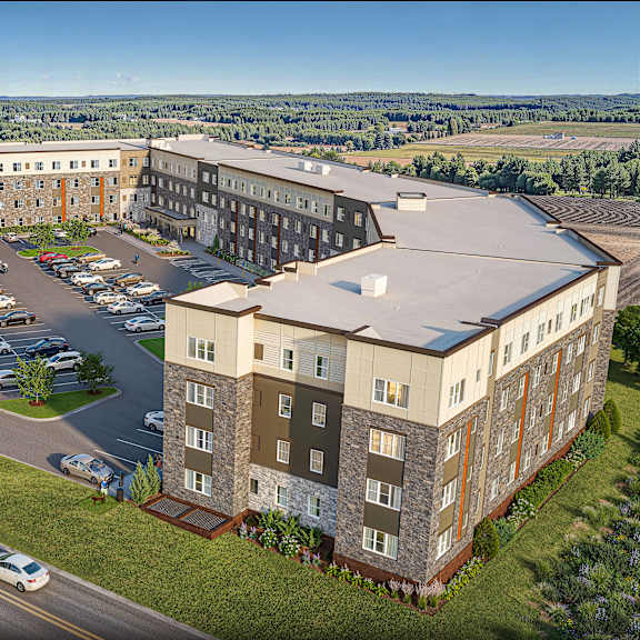 a large building with a parking lot in front of it.