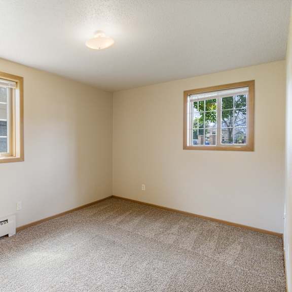 a room with a window and a carpeted floor at ames lake neighborhood apartments, st paul, mn, 55106