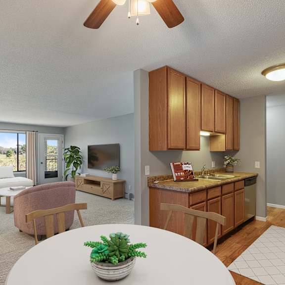 a living room with a couch, chair, and a table with a plant on it at heritage hills apartments, bloomington