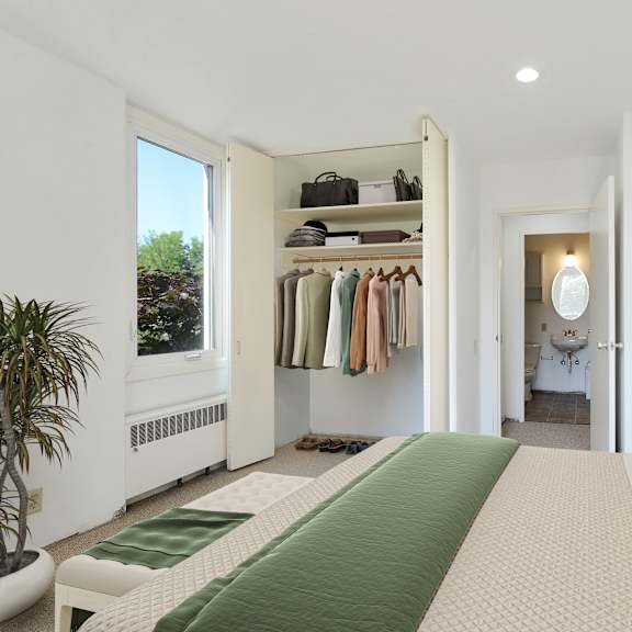 a bedroom with a bed and a closet at humboldt senior 55+ apartments, saint paul, mn, 55107