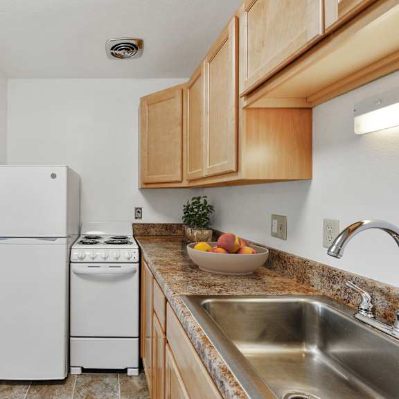 a kitchen with a sink and a refrigerator at humboldt senior 55+ apartments, saint paul, 55107