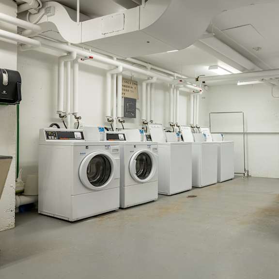 a row of washing machines and dryers in a laundry room at humboldt senior 55+ apartments, minnesota, 55107