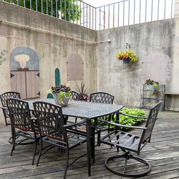 a patio with a table and chairs against a wall at humboldt senior 55+ apartments, saint paul, mn