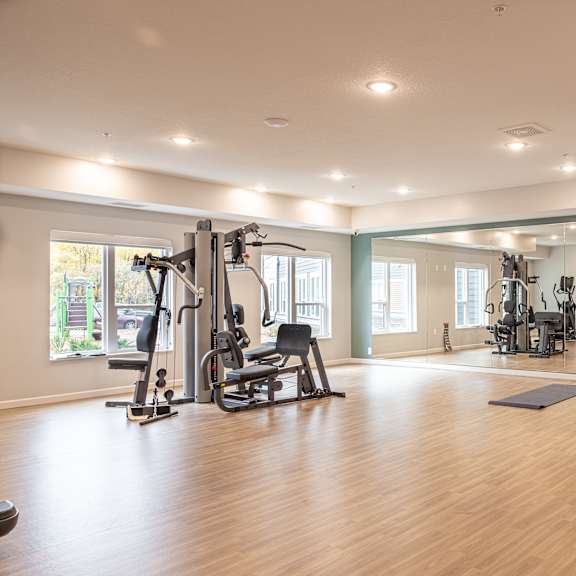 a gym with exercise equipment and a window