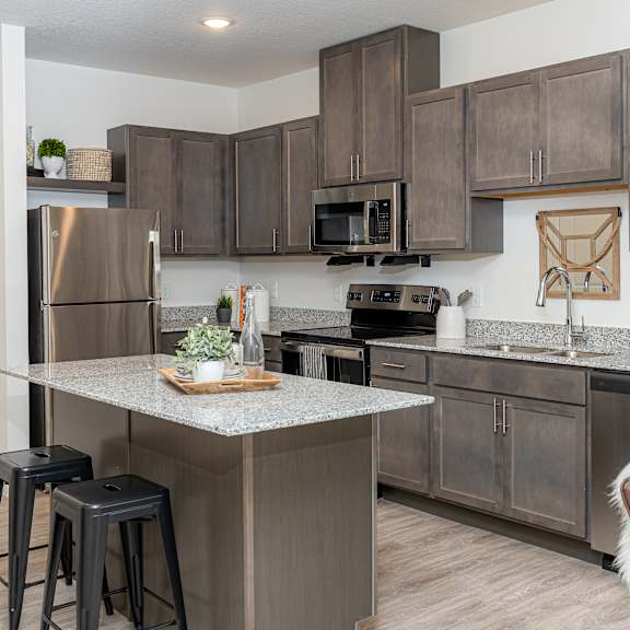 a kitchen with stainless steel appliances and granite counter tops