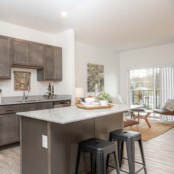 an open kitchen with stainless steel appliances and granite counter tops