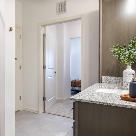 a bathroom with a shower and a sink and a mirror